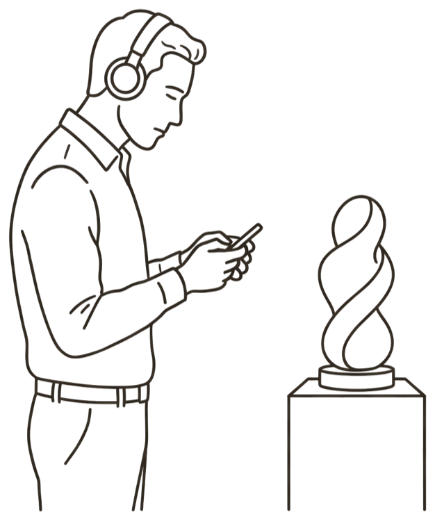 A visitor with headphones, head down over
          a phone beside a sculpture.